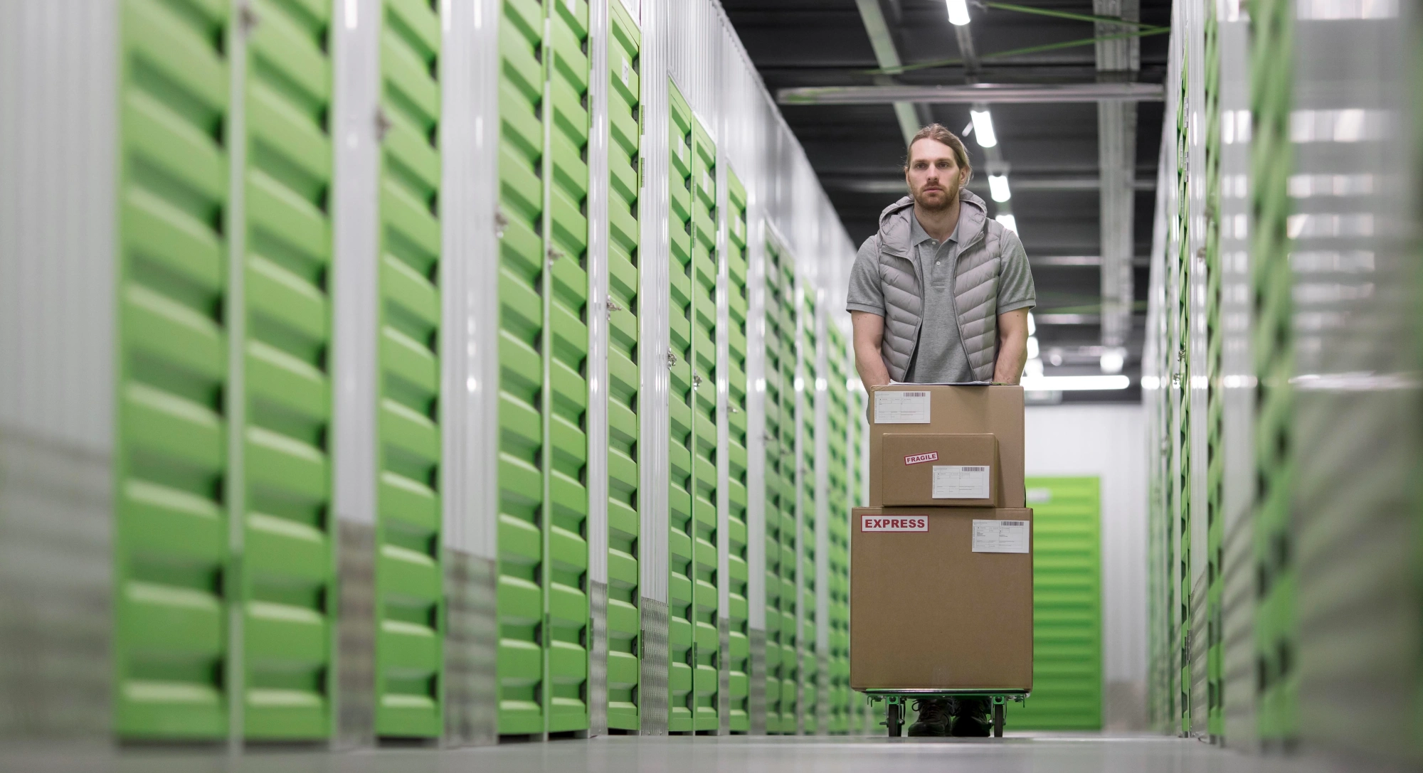 Man pushing cart through storage facility